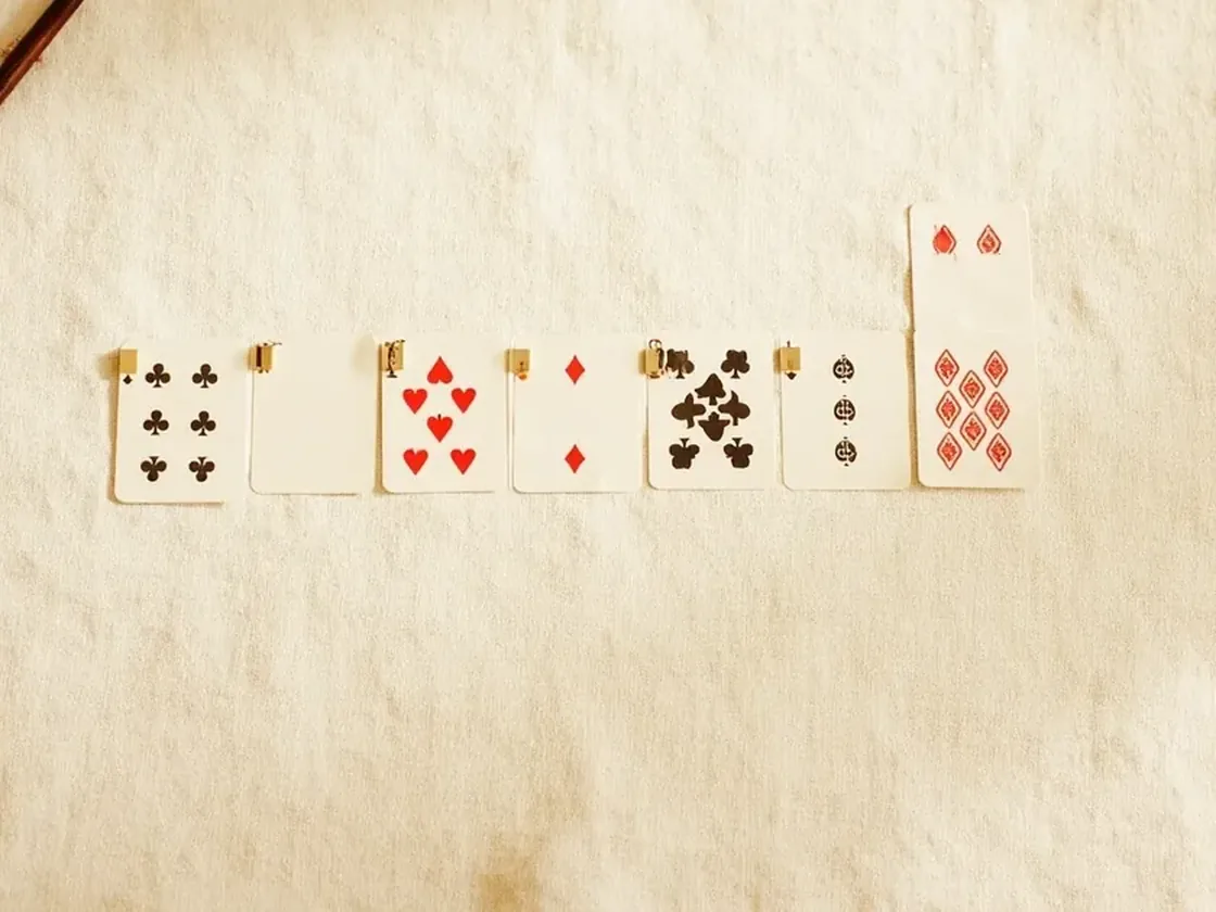 Close view of card groups on linen for checking sequences and sets before declaration