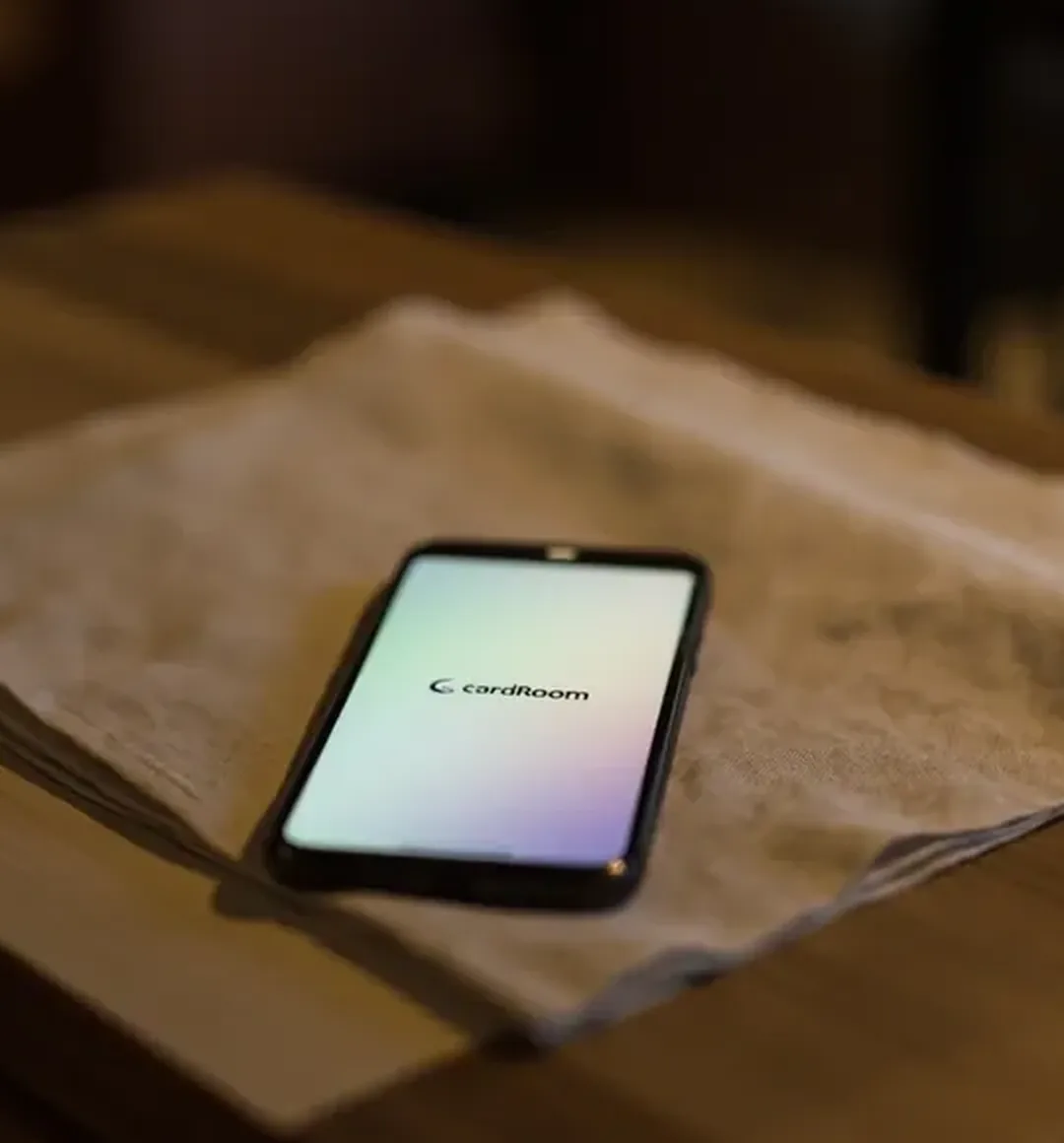 Portrait detail of a smartphone on folded linen for a lobby-legibility review